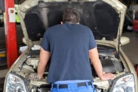 Mechanic Looking Under Hood